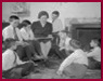 thumbnail for Tips and Tricks showing Female teacher on couch reading to young boys gathered around her on floor.